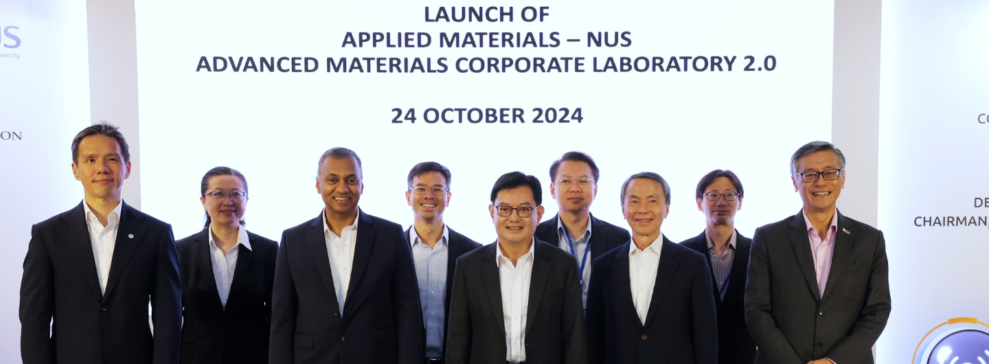 Group of 9 people in business attire at "Applied Materials - NUS" launch event.